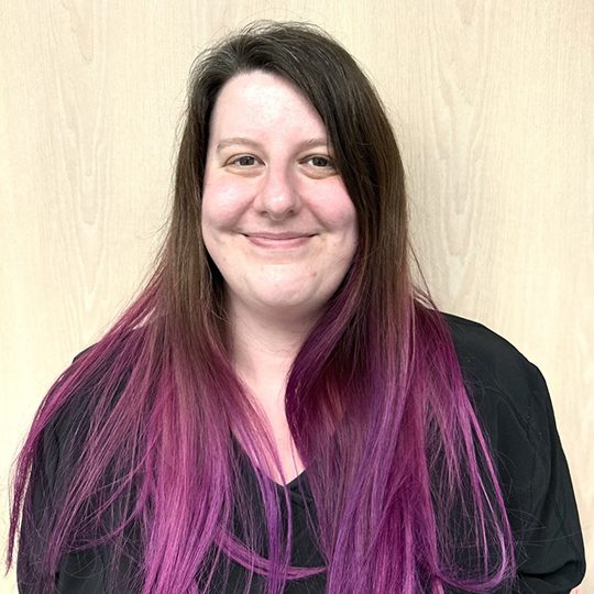 Amanda wearing a black top and smiling